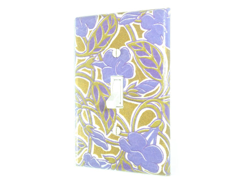 A large bluish purple floral design covers this single toggle swtich plate, with a metallic gold background weaving in and out of the tan leaves and vines.