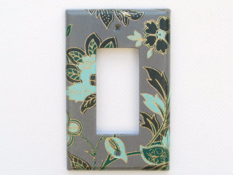 Turquoise and Green Flowers contrast beautifully against the dark background of this Single Dimmer Switch Plate by The Orange Chair Studio.
